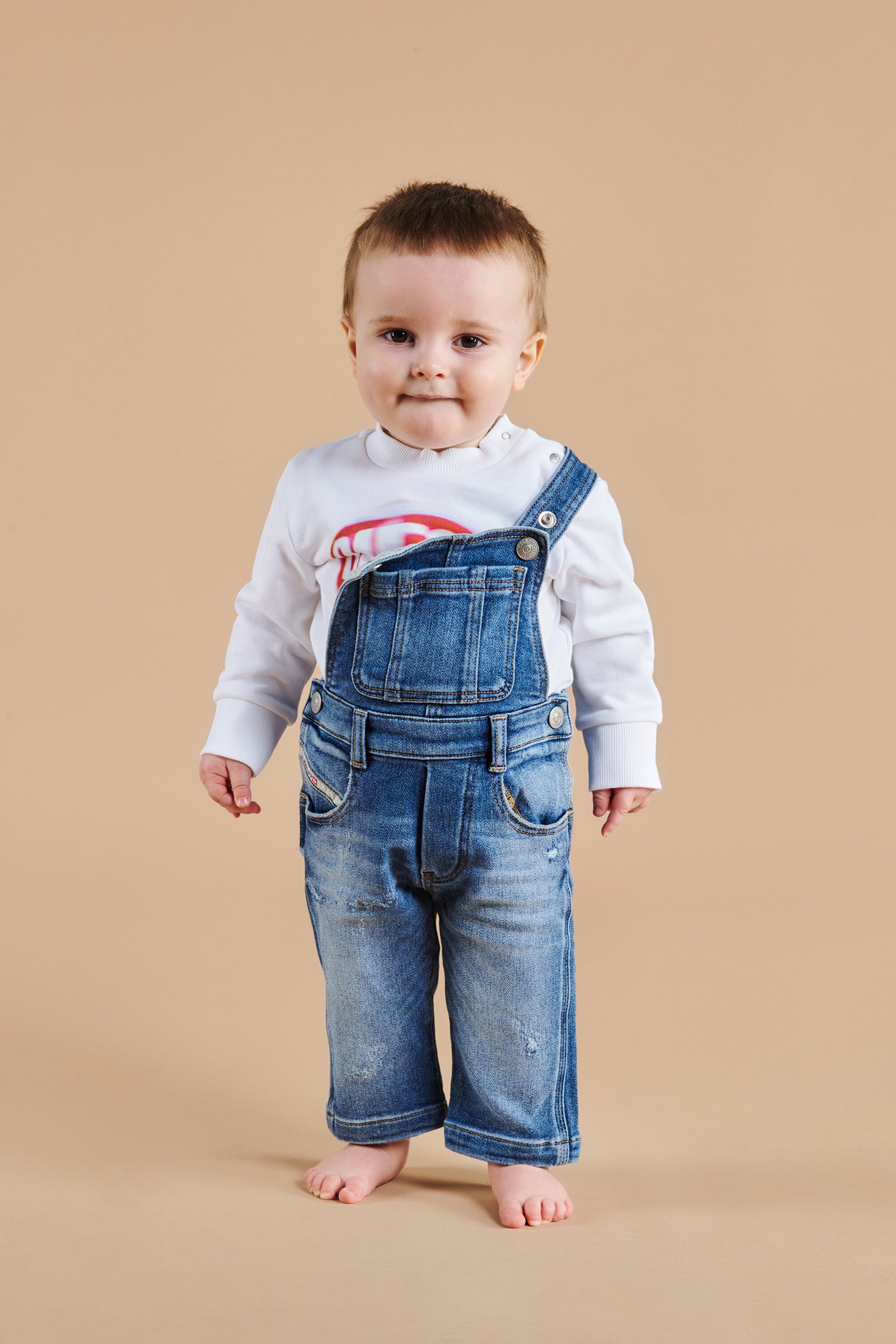 Medium blue JoggJeans® long overalls with abrasions