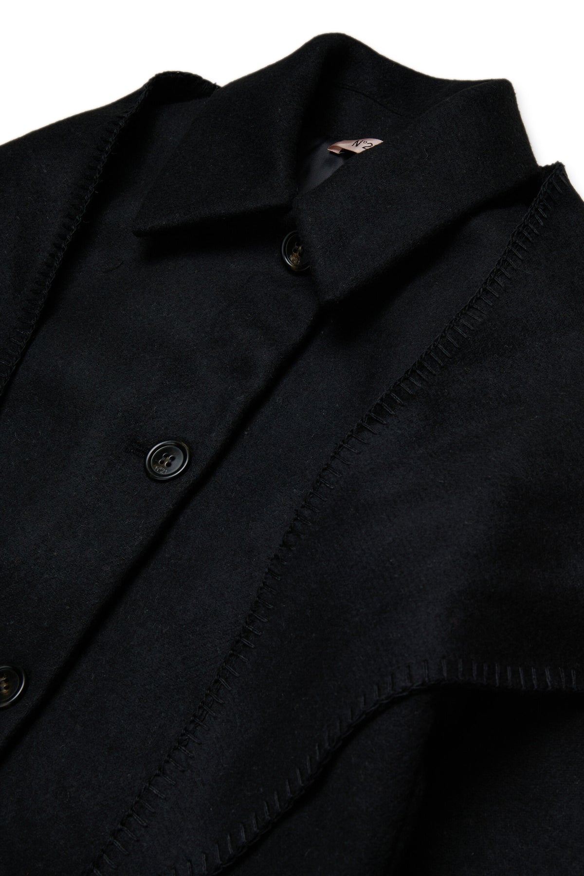 Coat with decorative cape